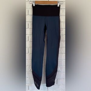 Lululemon mesh down the entire sides of the pants. Midnight teal and black.